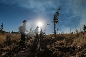 A team member deploying AI-powered equipment amidst wildfire smoke