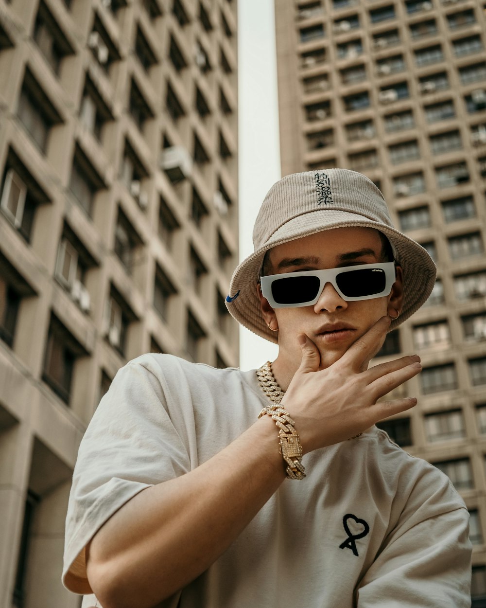 woman in white shirt wearing white sunglasses and white hat