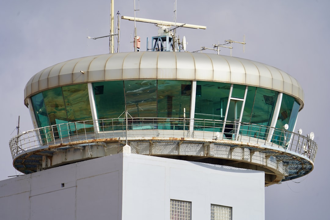 white and green concrete building, An ATC control tower in Bangalore airport