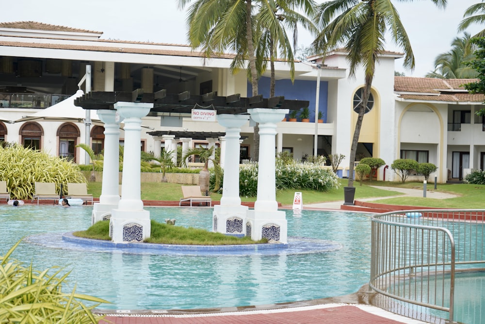 white concrete building near swimming pool during daytime