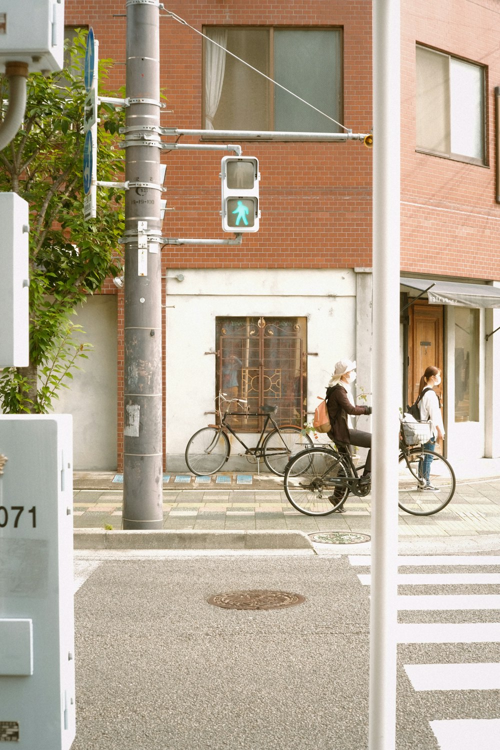 man in black jacket riding bicycle on road during daytime