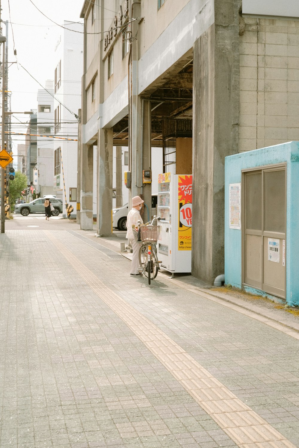 man in white shirt riding bicycle on sidewalk during daytime