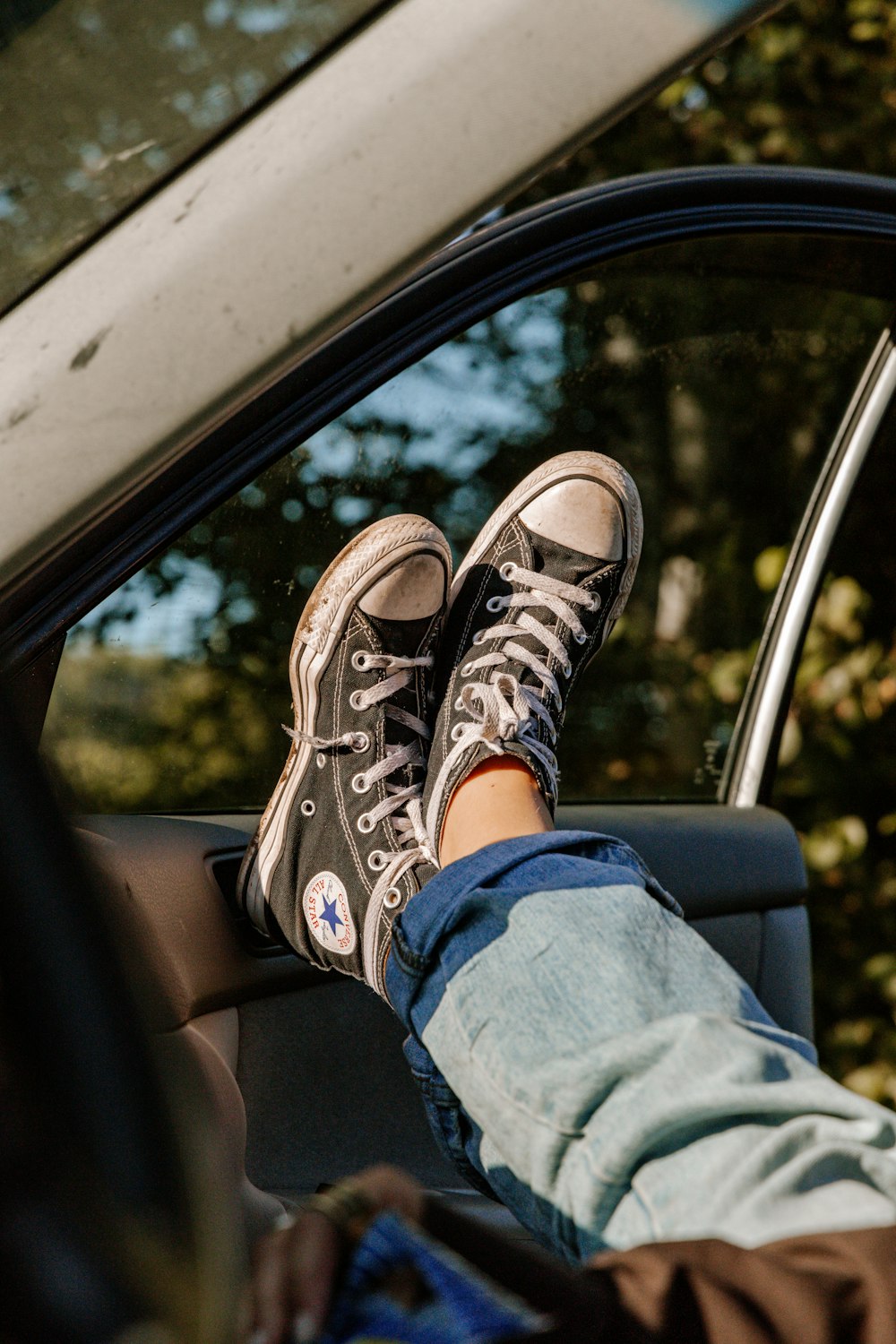 person in blue denim jeans and brown and white hiking shoes