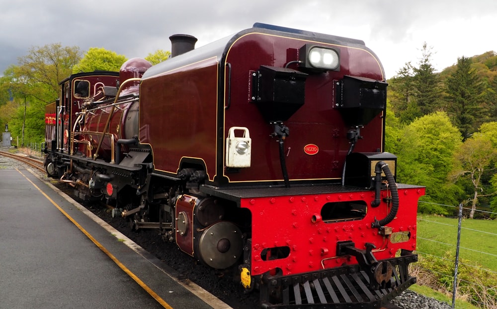 red and black train on rail during daytime