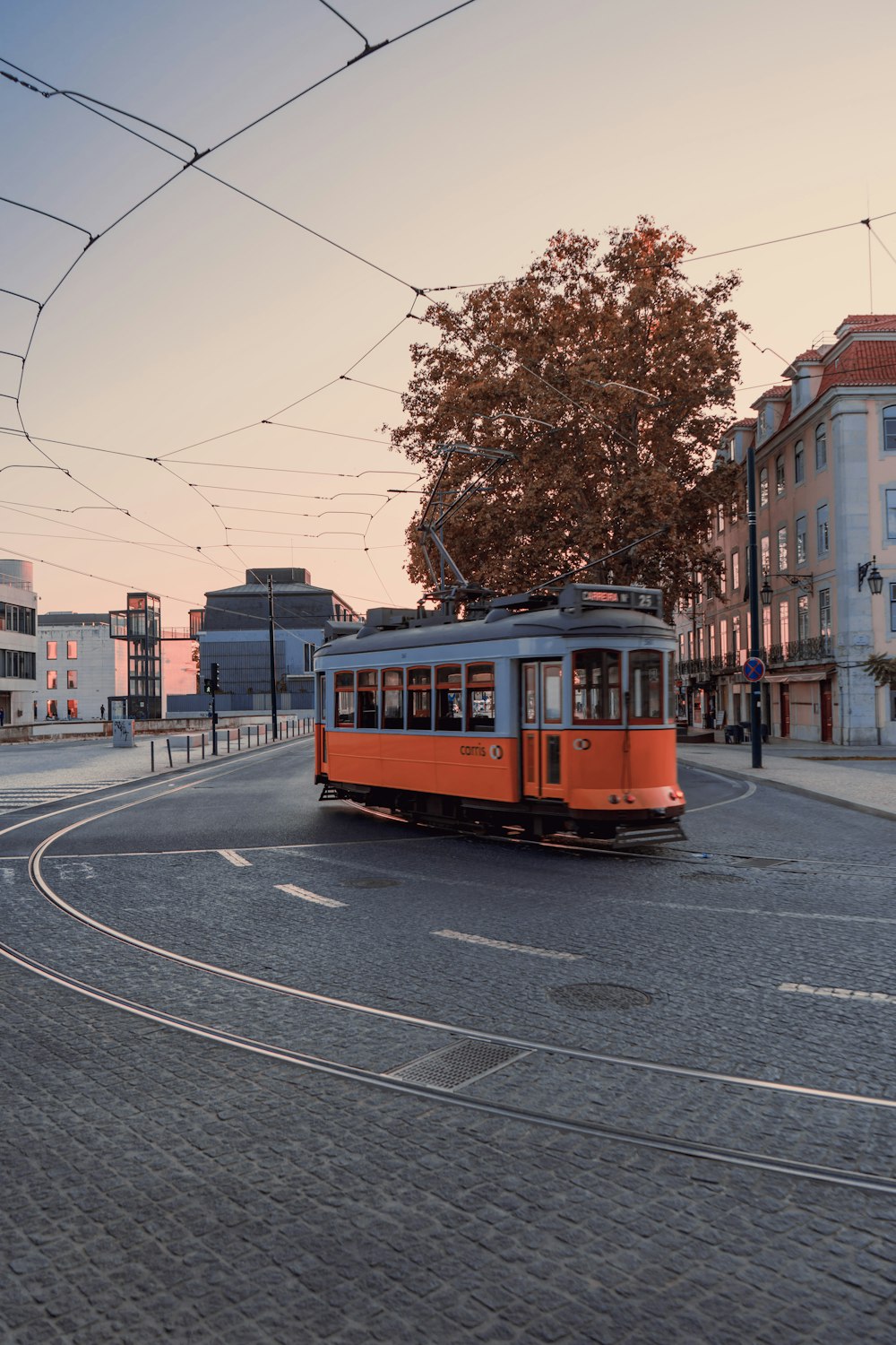 red and yellow tram on road during daytime