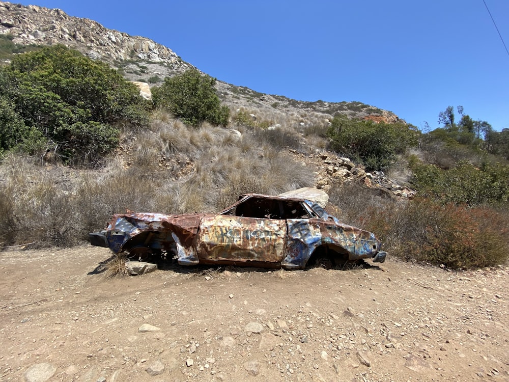 blue and brown car on brown sand during daytime