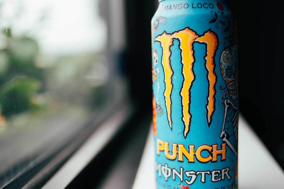 blue and yellow monster energy drink can