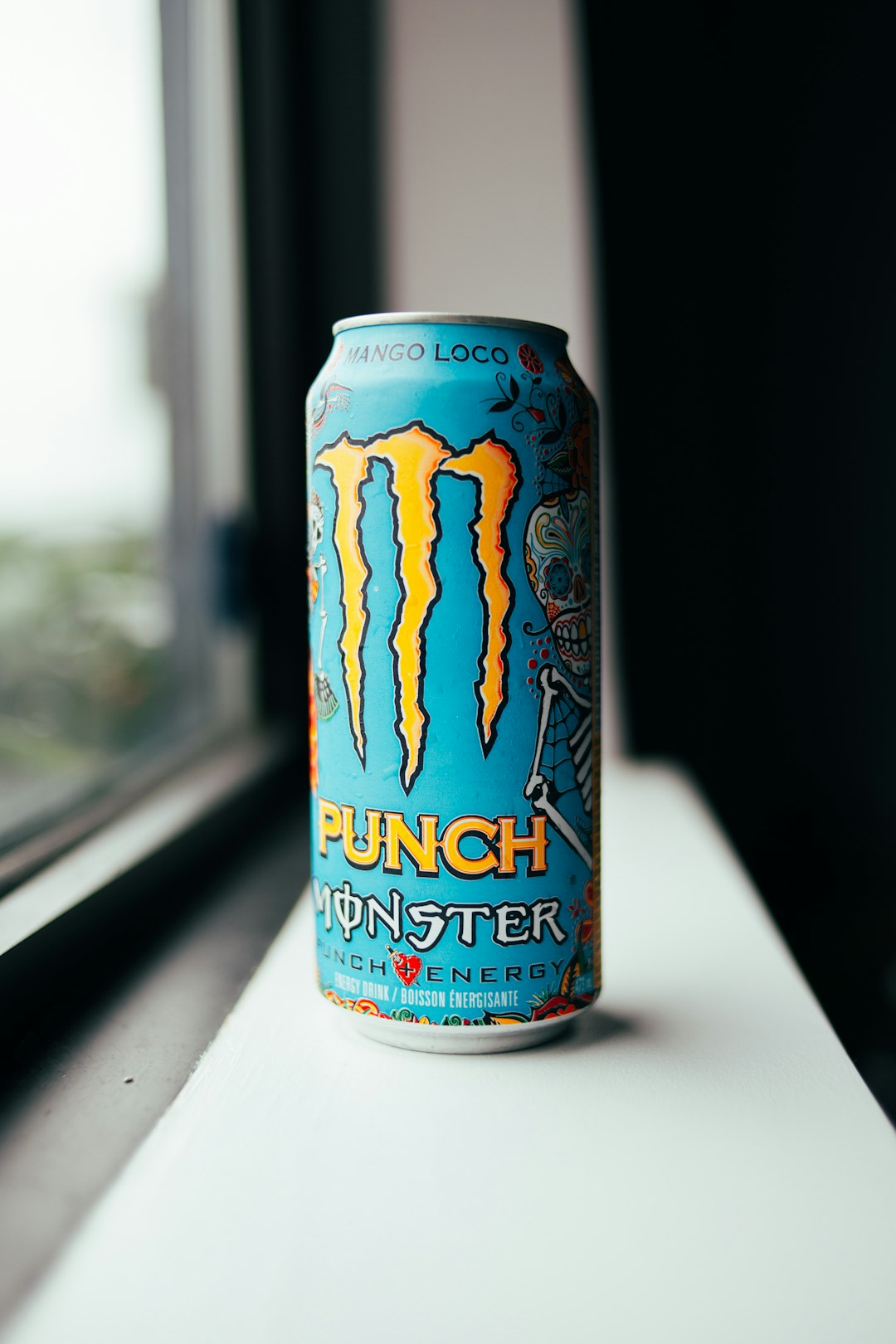 blue and orange monster energy drink can