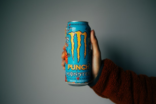 person holding blue and orange can