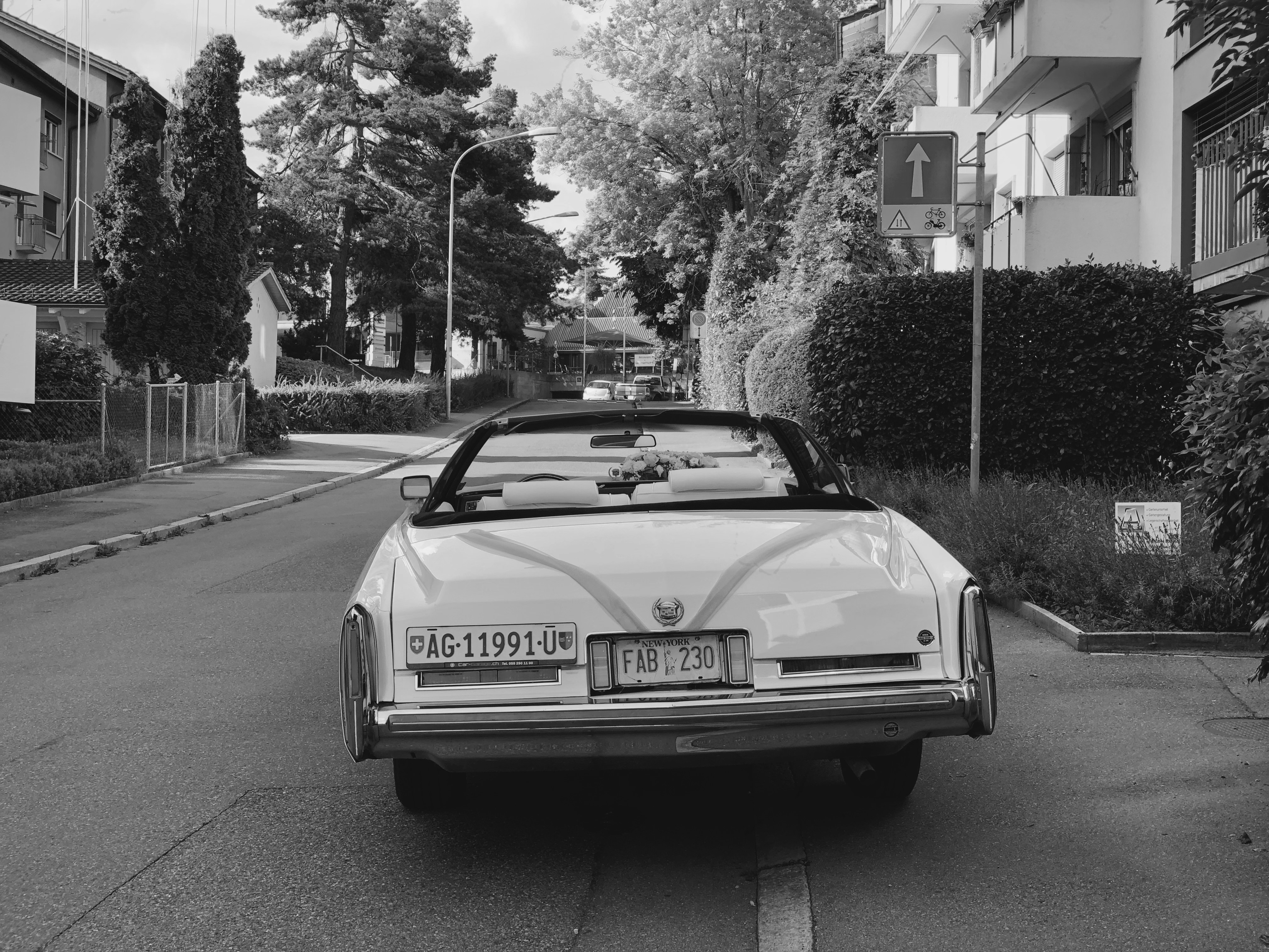 grayscale photo of mercedes benz coupe on road