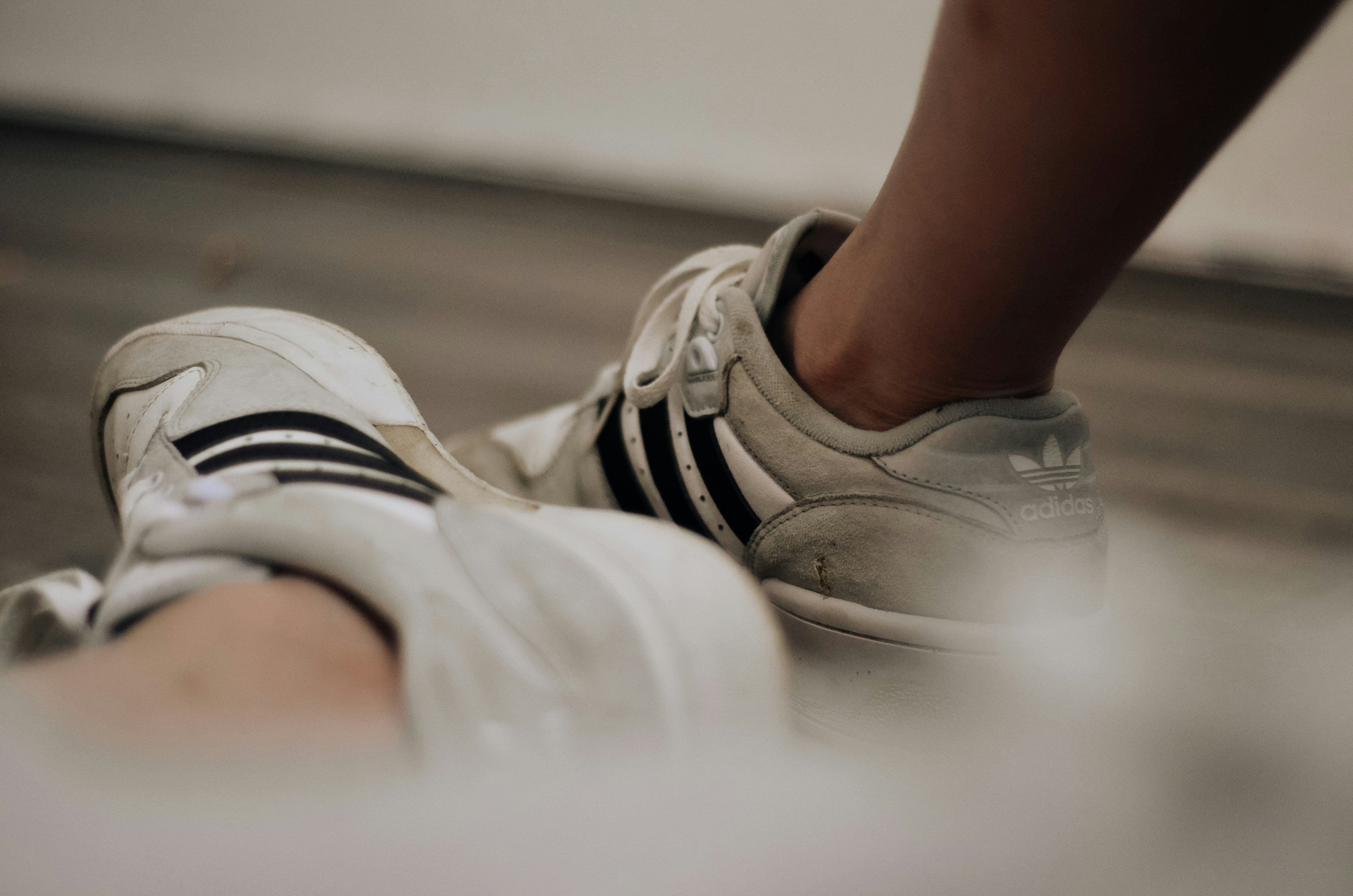 A person placing their workout sneakers by the front door as a visual cue - habit building strength sessions
