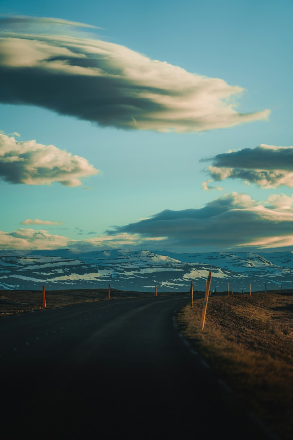 gray asphalt road under blue sky during daytime