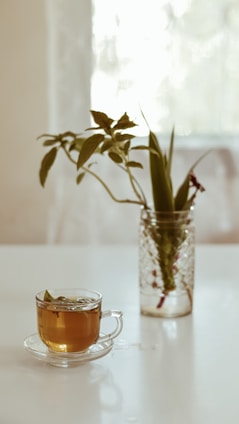 A serene morning scene with a woman enjoying a cup of herbal tea surrounded by natural skincare products.