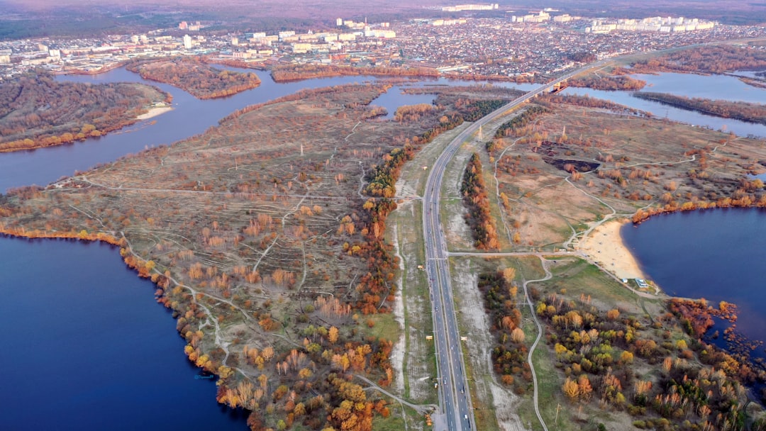 aerial view of road near body of water during daytime