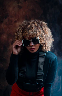 a woman wearing sunglasses and a black sweater