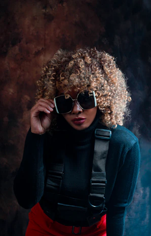 a woman wearing sunglasses and a black sweater