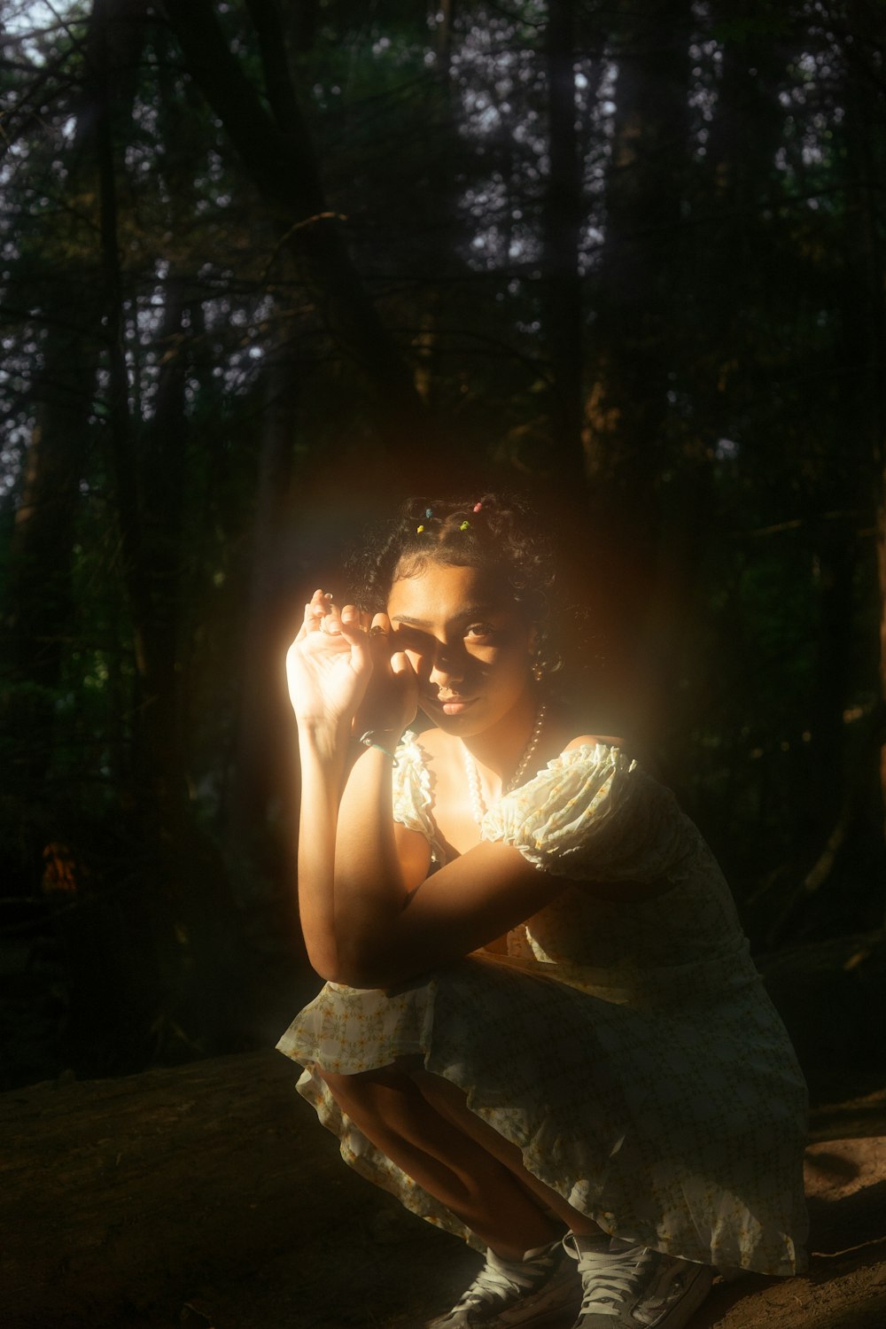 woman in white dress sitting on brown wooden bench