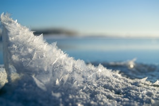 white snow on blue sky during daytime
