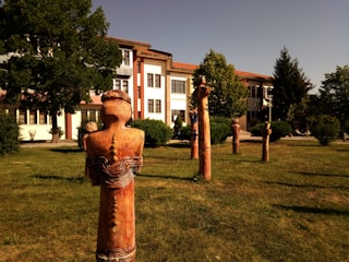 A collection of wooden sculptures displayed in an architectural setting.