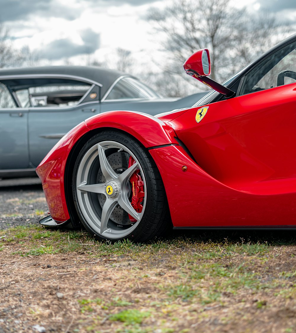 red ferrari 458 italia on green grass field during daytime