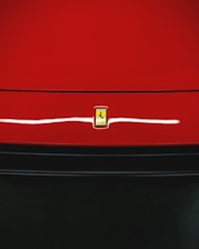 Close-up of a shiny red Honda car with a smiling customer shaking hands with the sales agent.