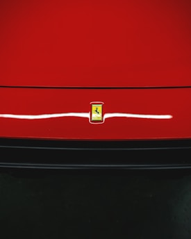 A car on the road with a safety emblem.