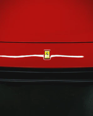 Close-up of a shiny car emblem on a freshly imported vehicle.