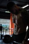 topless man in black shorts
