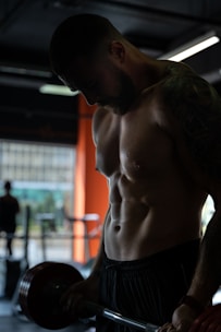 topless man in black shorts
