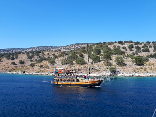 brown and white boat on sea during daytime in Saranda Albania