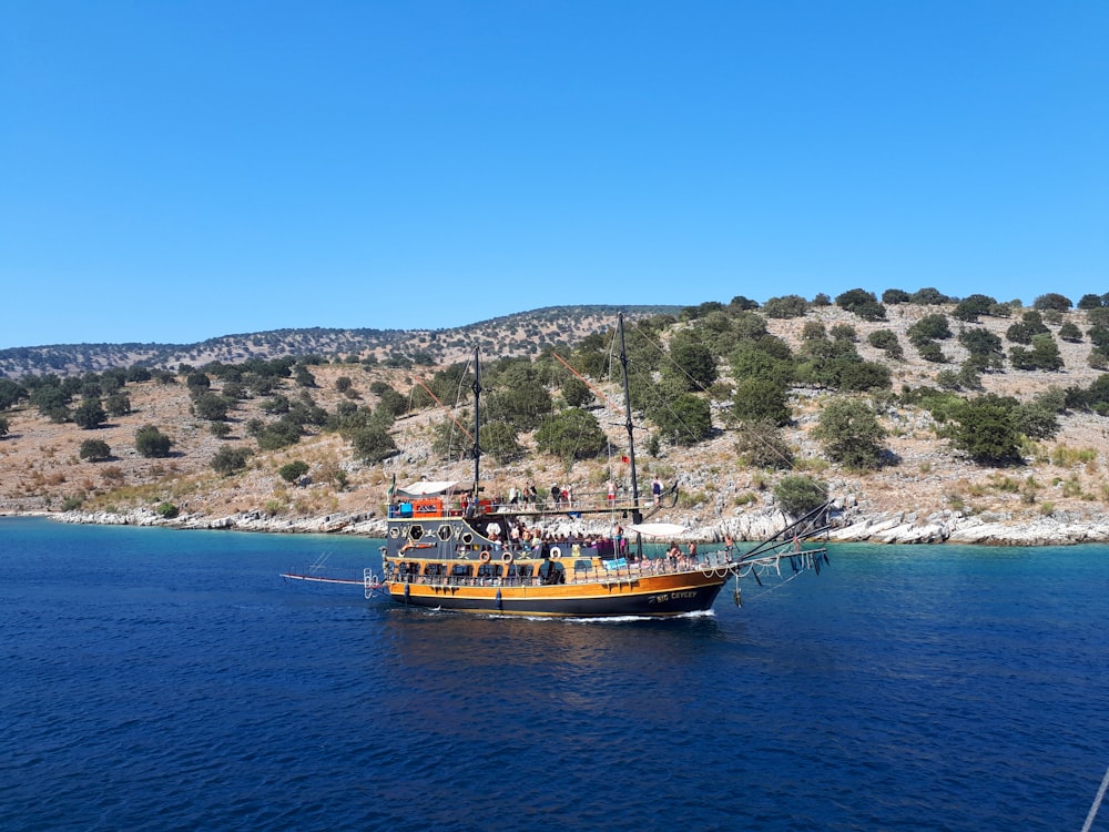 brown and white boat on sea during daytime