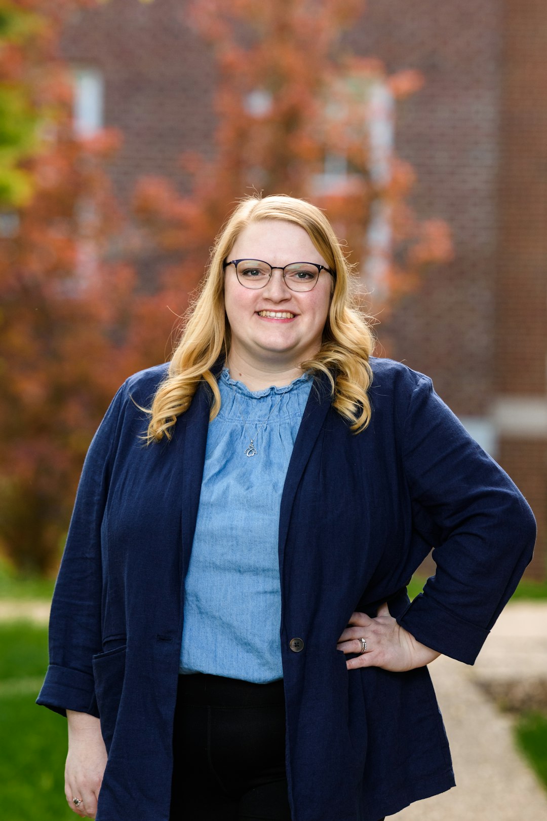 woman in black jacket wearing eyeglasses smiling