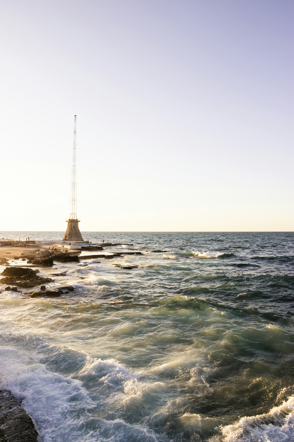 brown rock formation on sea water during daytime