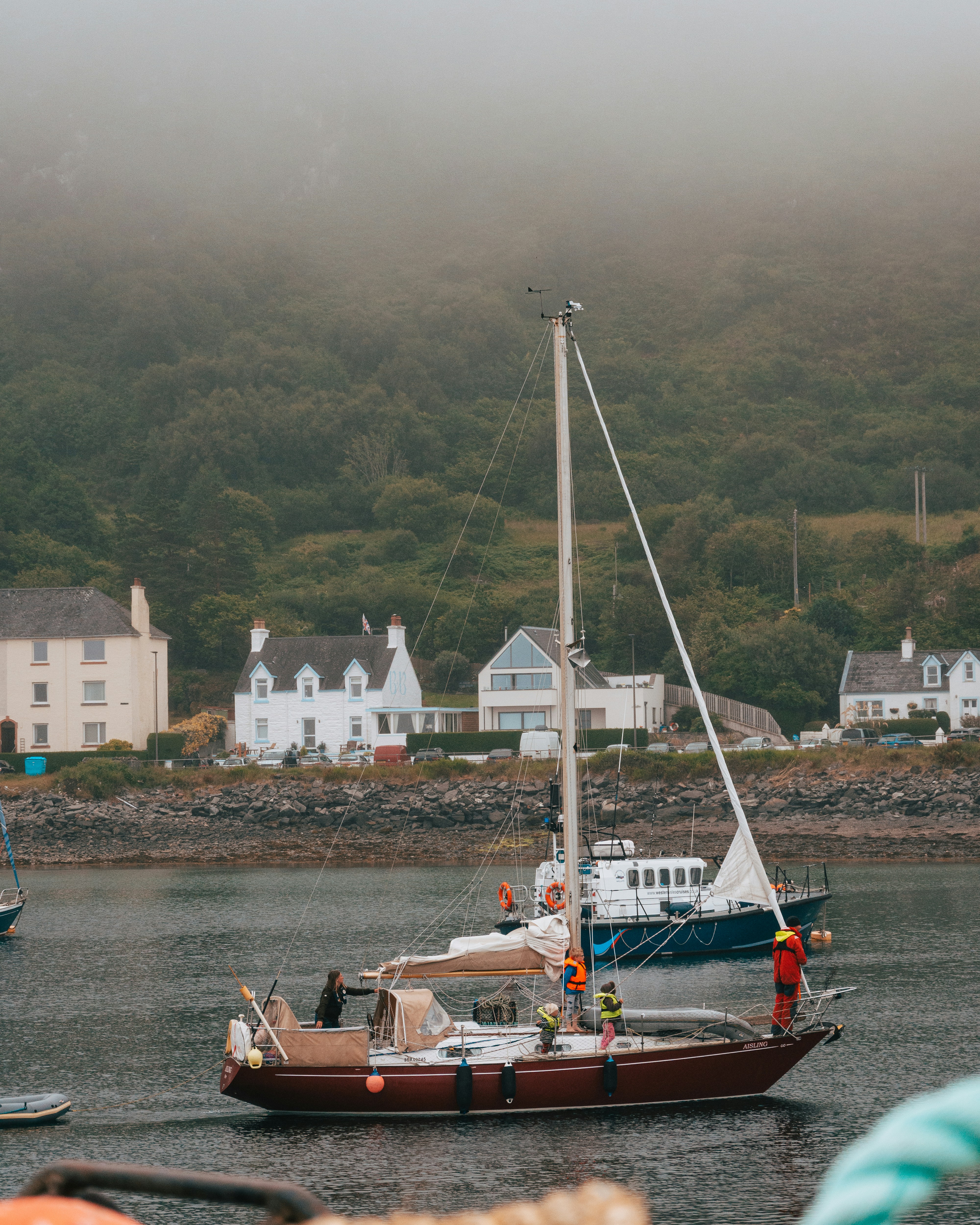red and white boat on water near white concrete building during daytime