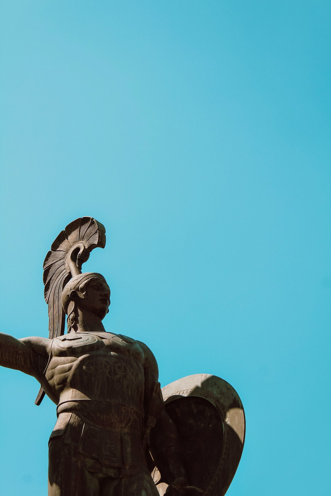 low angle photography of angel statue under blue sky during daytime