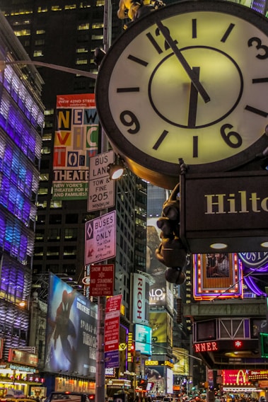 black and white analog clock at 11 00