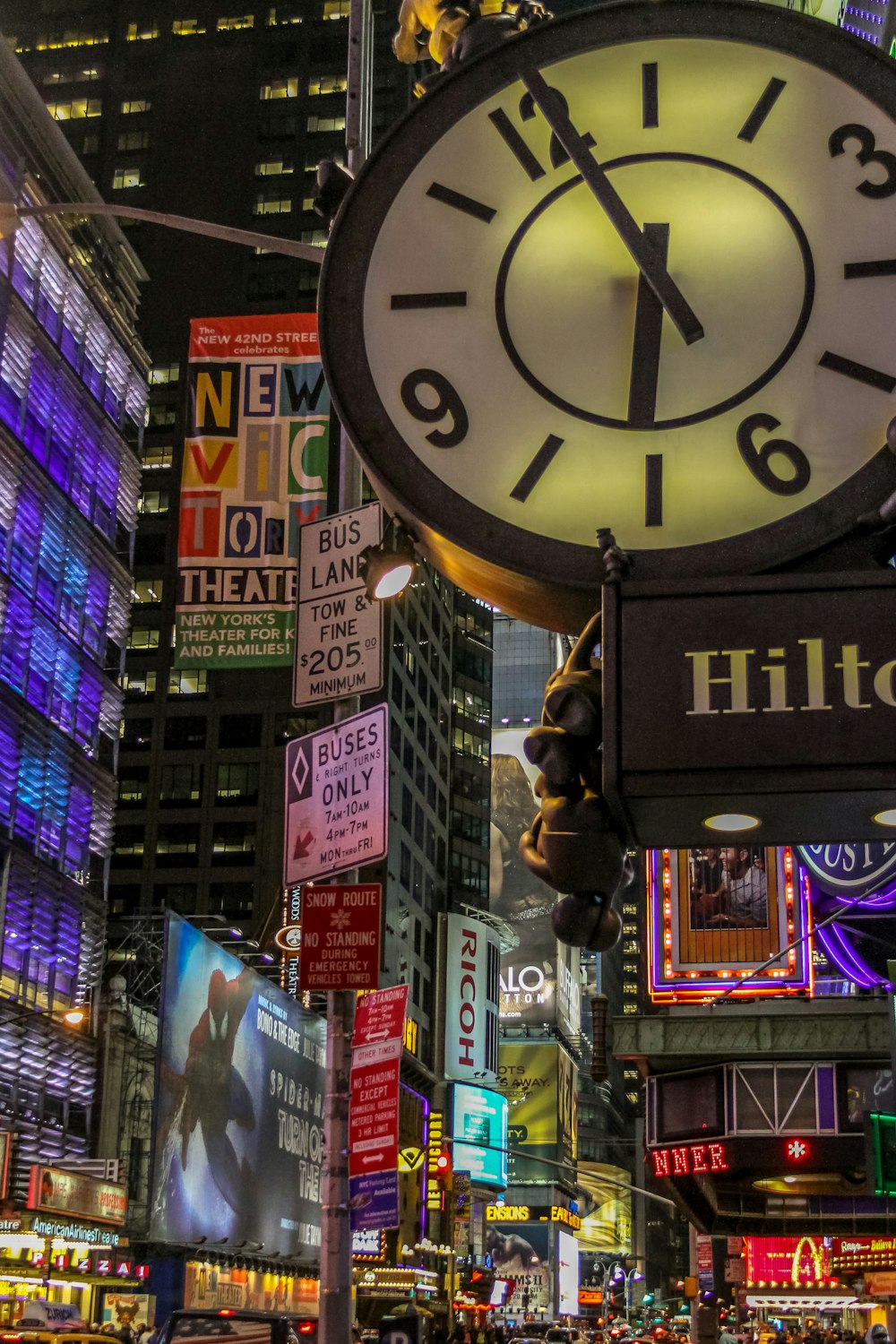 black and white analog clock at 11 00