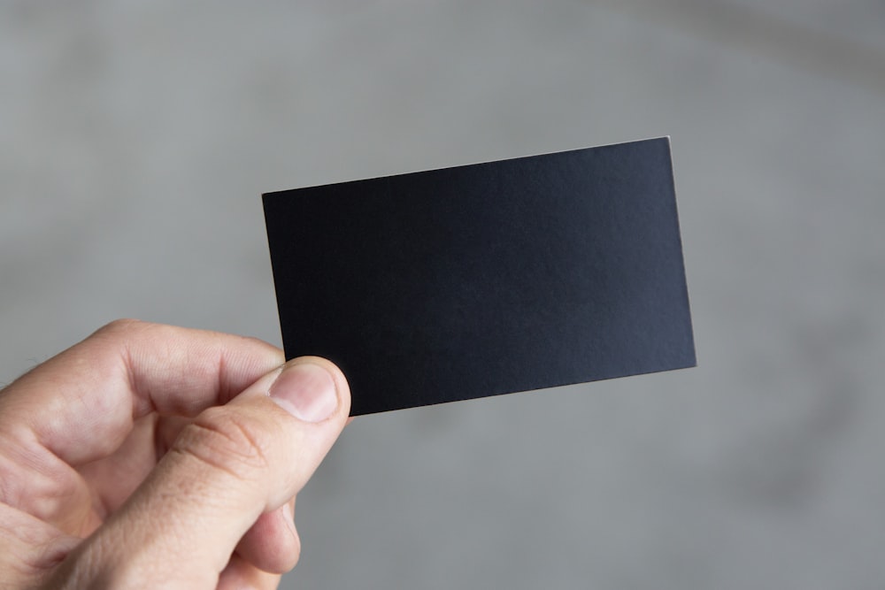 Stack of black blank business cards mockup on black wood table background,  Stock Illustration