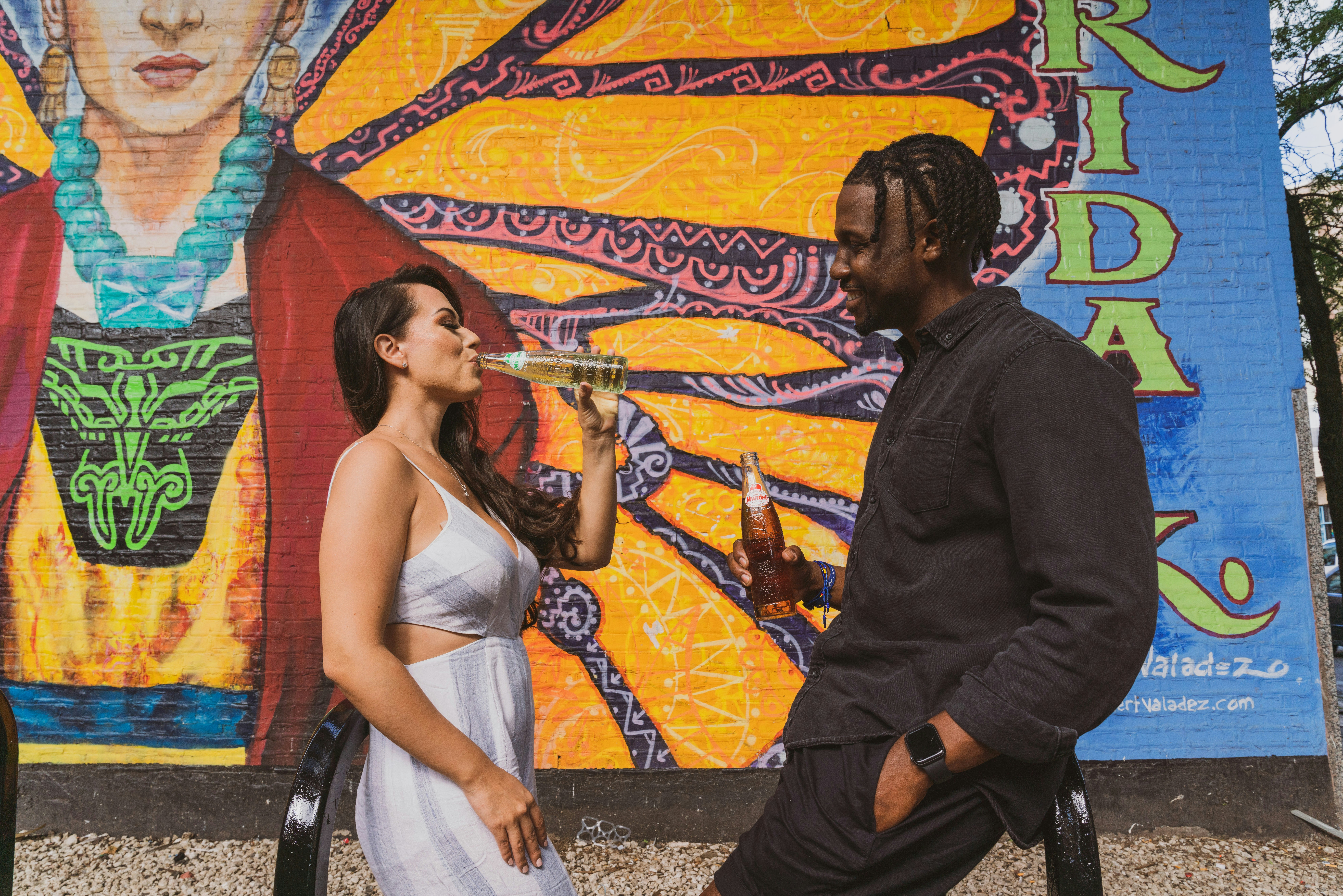 man in black long sleeve shirt kissing woman in white sleeveless dress, 