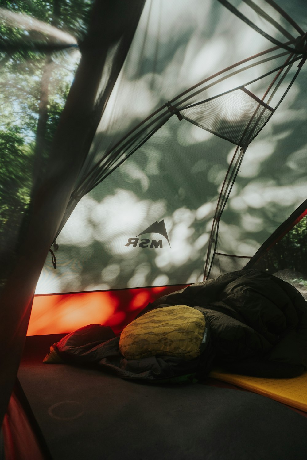 person in black pants lying on hammock