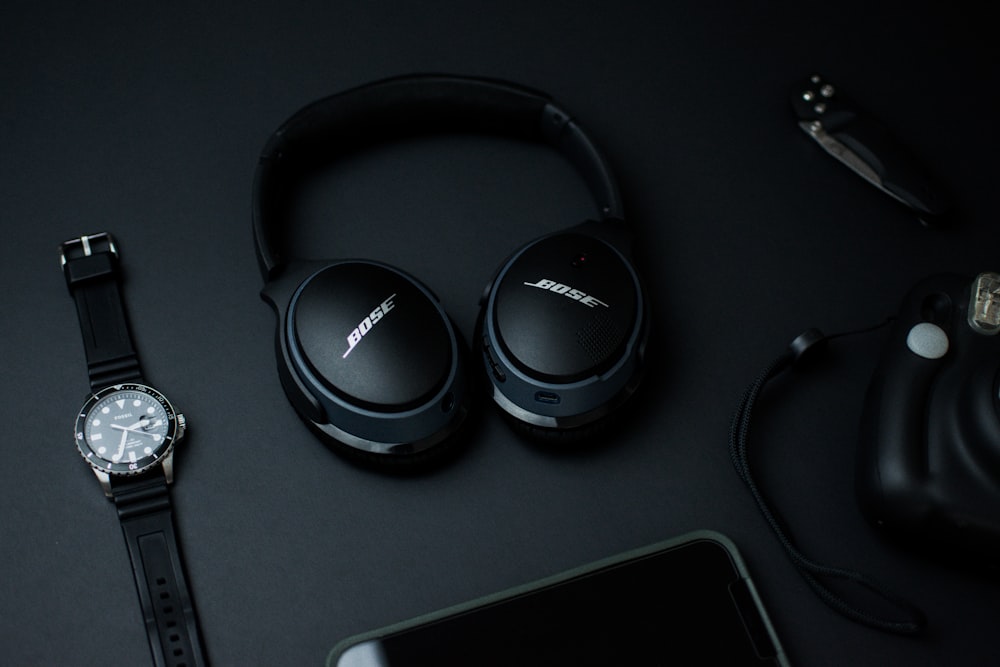 black sony headphones on black tablet computer