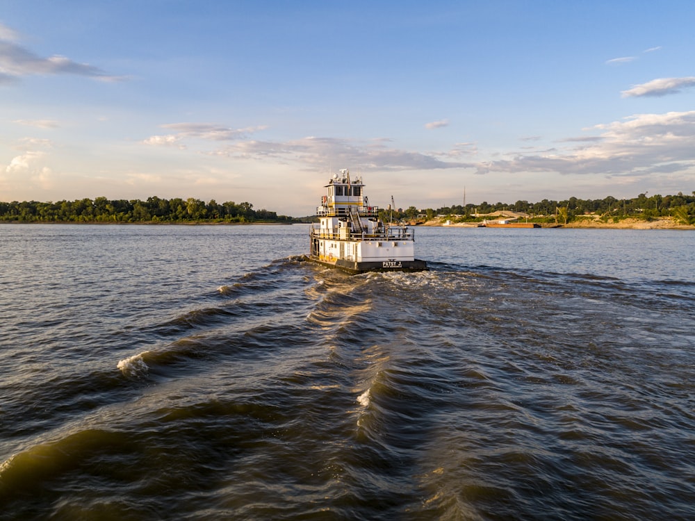 white and brown concrete building on body of water under blue sky during daytime