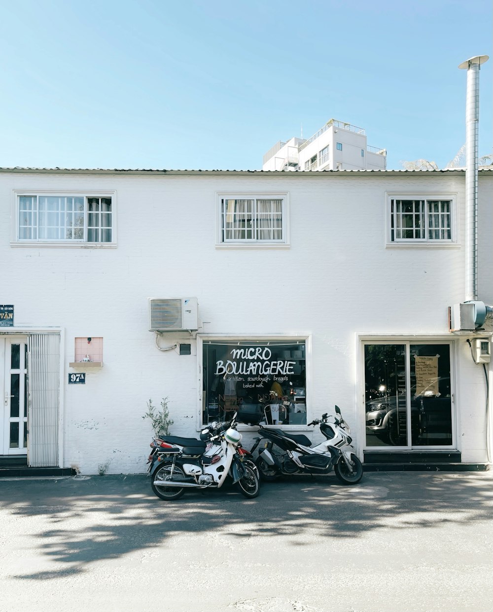 motorcycle parked in front of white building