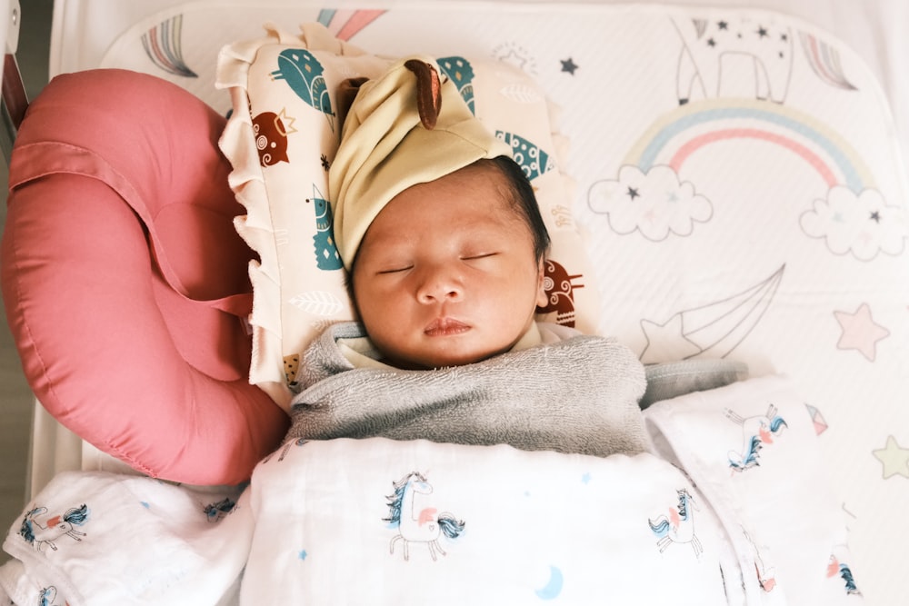 baby in white and pink floral shirt