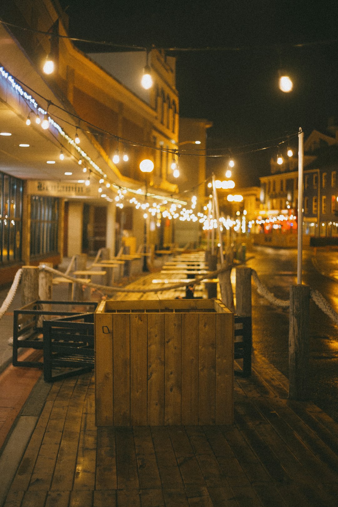 white and brown wooden table and chairs near brown wooden bench during night time
