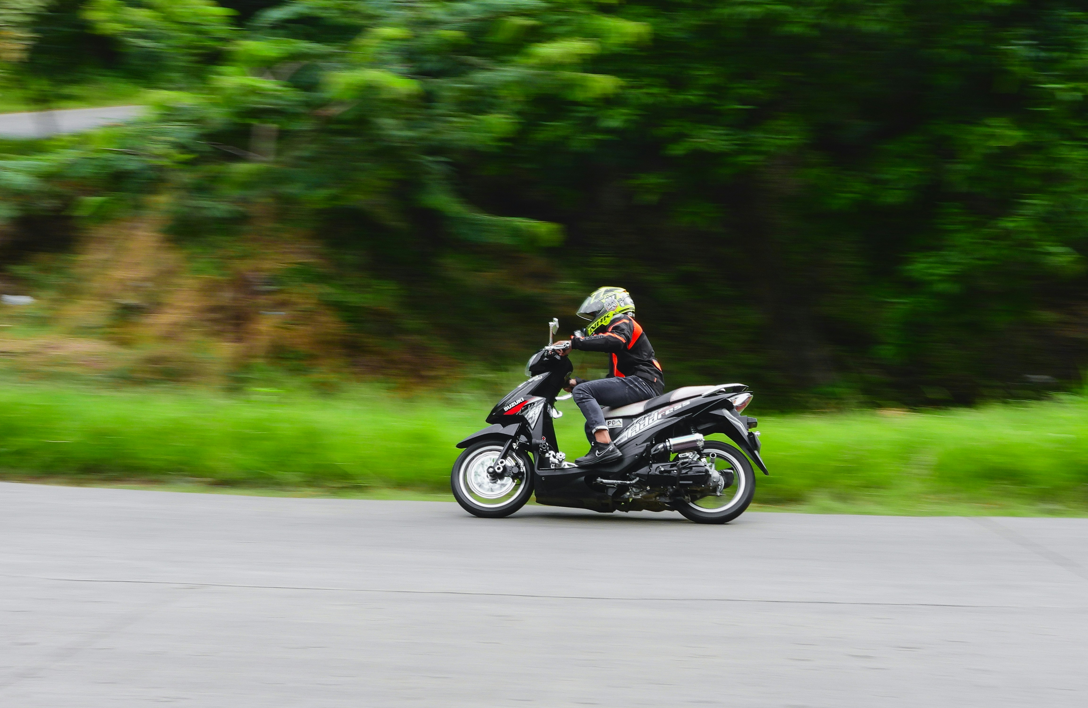 man riding motorcycle on road during daytime