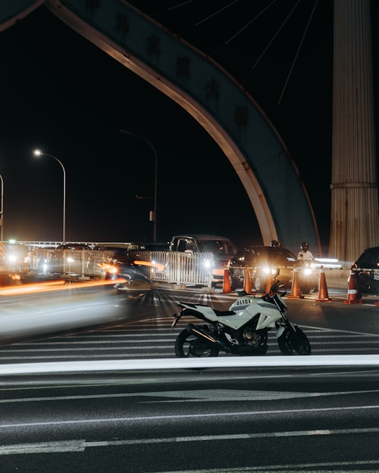 black motorcycle on road during night time in SinaMalé Bridge Maldives