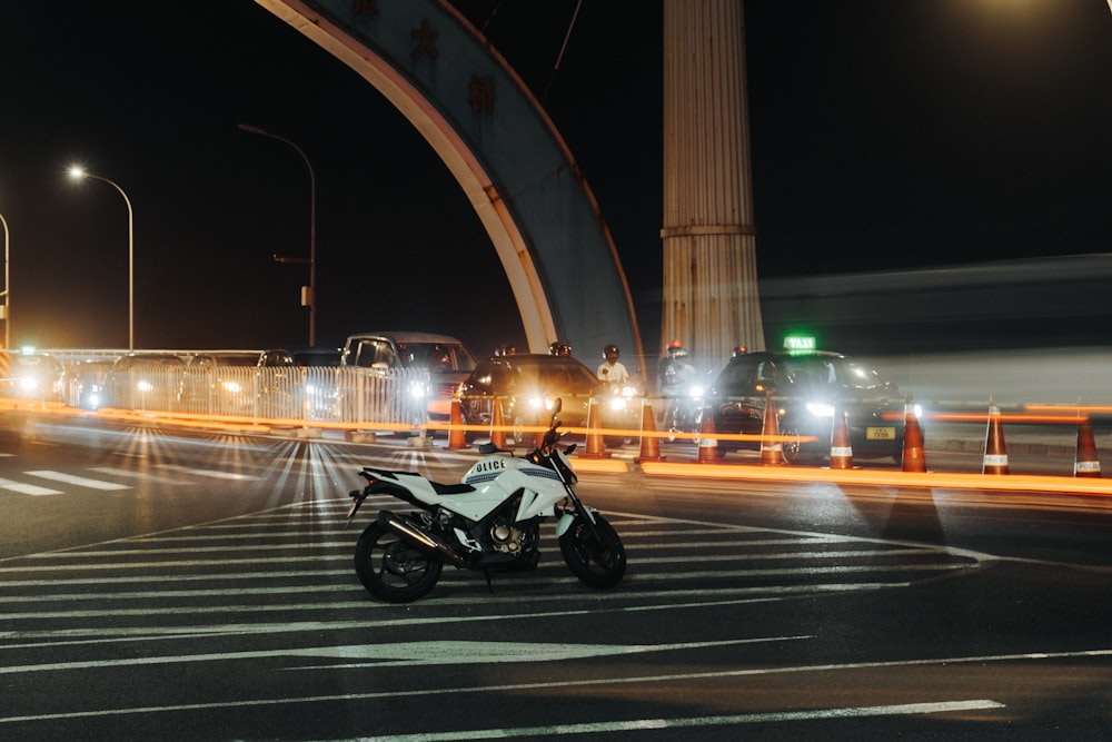 black motorcycle on road during night time