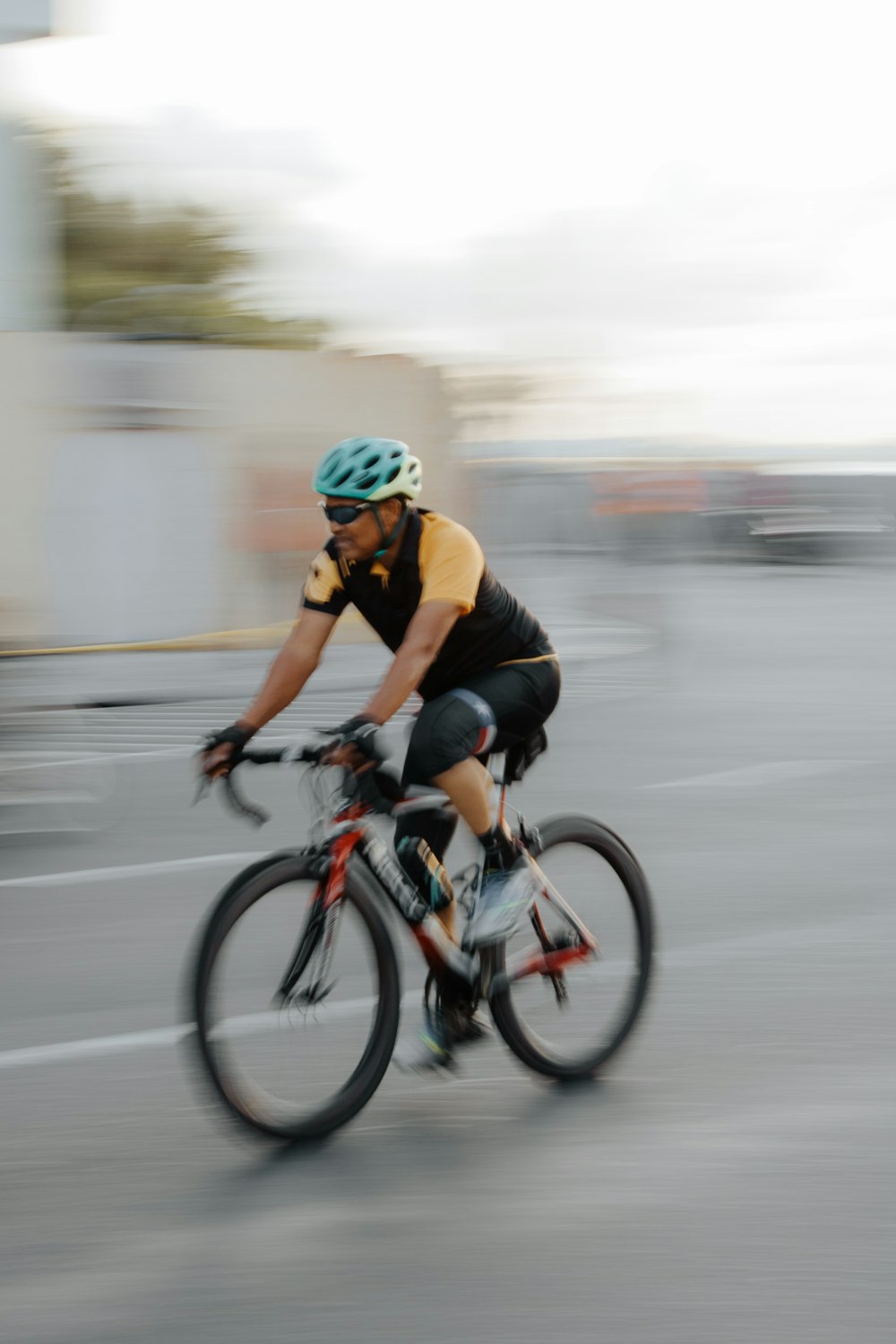 man in black and red shirt riding on bicycle