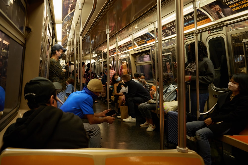 people sitting on chair inside train